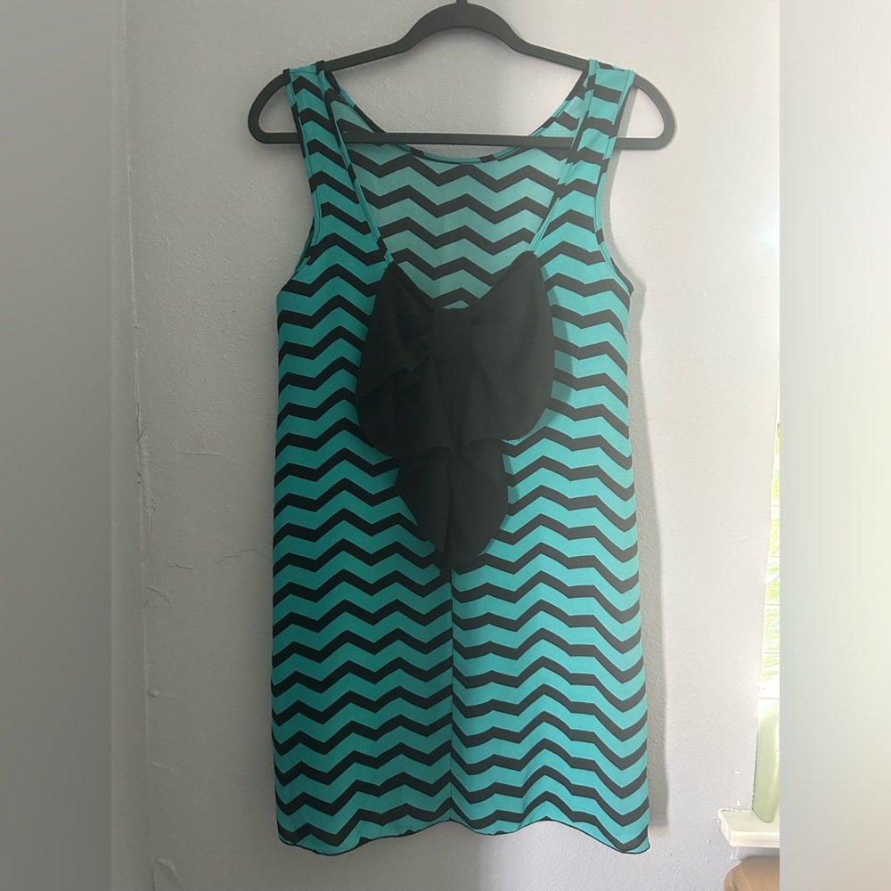 Black and green dress with a bow in the middle